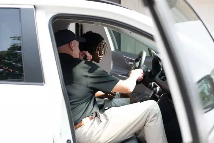 A student behind the wheel with an instructor