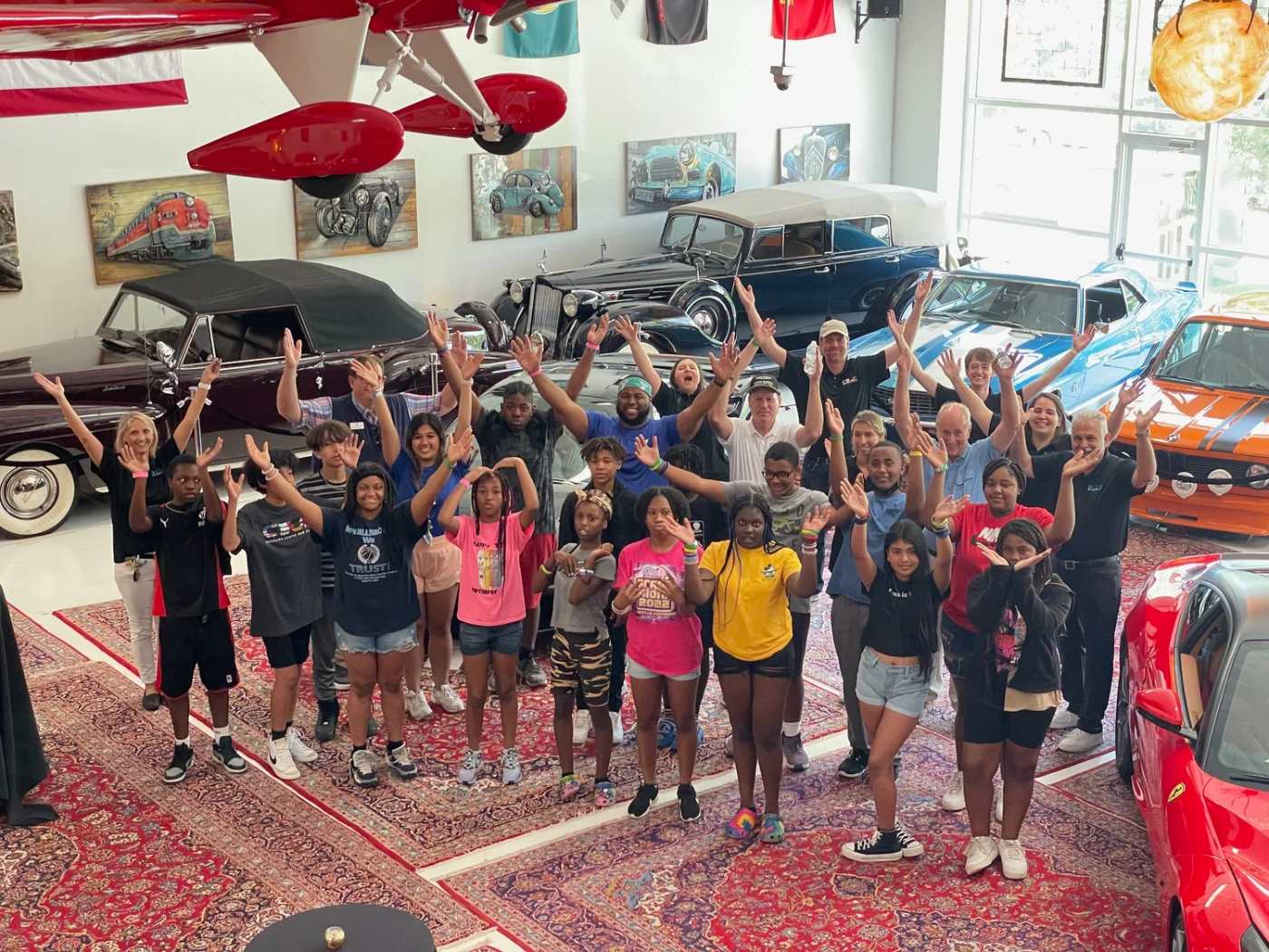 A child meeting an exotic car through the Ride of Your Life Foundation
